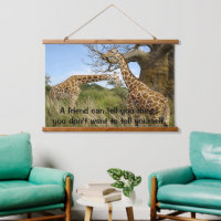 Giraffes out in the field by some trees