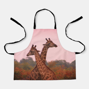 Giraffes with a pink sky  apron