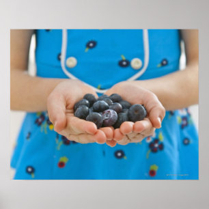 Girl holding fresh blueberries poster