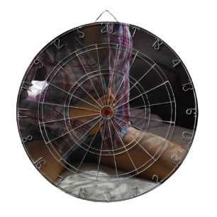 Girl in Flannel Shirt kneeling on a Bed Dartboard