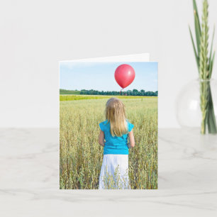 girl in wheat field with red balloon card
