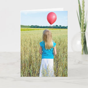 girl in wheat field with red balloon card