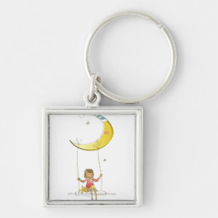 Girl swinging on a rope hanging from crescent moon key ring