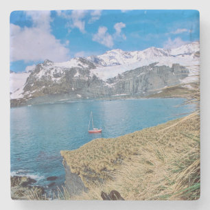 Glaciers and sailing yacht in background stone coaster