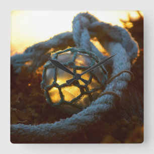 Glass float glows at sunset, Alaska Square Wall Clock