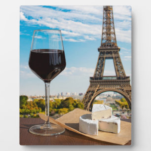 Glass of wine with brie cheese on Eiffel tower Plaque