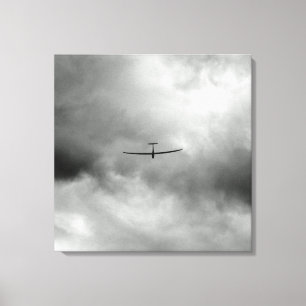 Glider flying in gray sky canvas print