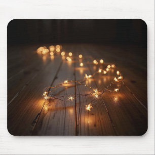 Glowing Light String On a Wood Floor Mouse Pad