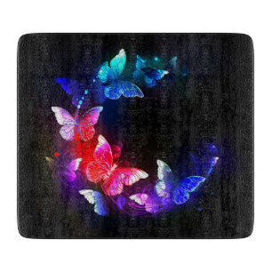 Glowing Neon Night Butterflies on Black background Cutting Board