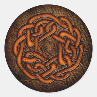 Glowing orange celtic ornament on leather classic round sticker