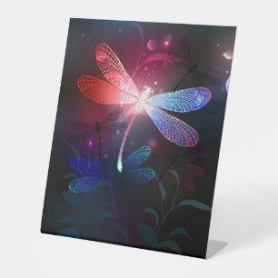 Glowing red dragonfly pedestal sign