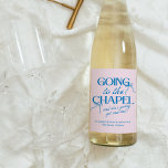 Going to the Chapel Bachelorette Weekend Wine Label<br><div class="desc">The Going to the Chapel Bachelorette Collection blends playful charm with classic bridal style. Featuring a soft pink background paired with bold blue typography, this suite captures the excitement of a bride-to-be heading down the aisle. Delicate bow illustrations and a mix of elegant serif and flowing script fonts add a...</div>