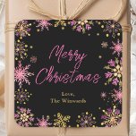 Gold and Pink Snowflakes Merry Christmas Square Sticker<br><div class="desc">This elegant and glamourous sticker can be personalised with your family name. It features watercolor gold and pink faux glitter snowflakes and sparkles on a black background. The text combines handwritten script and modern sans serif fonts for a classy and sophisticated look. This is perfect for giving Christmas gifts and...</div>