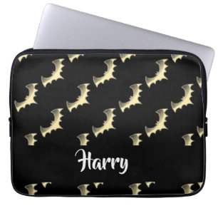 Gold bats on black laptop sleeve