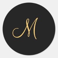 Gold-coloured initial M on black monogram round