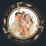 Gold Foliage Family Photo Black Christmas  Classic Round Sticker<br><div class="desc">Modern Elegant Calligraphy Black and Gold Family Photo Merry Christmas Script  Classic Round Sticker. This festive photo holiday design features a pretty faux gold botanical gold leaves with berries,  family name and year in gold script on black colour background.</div>
