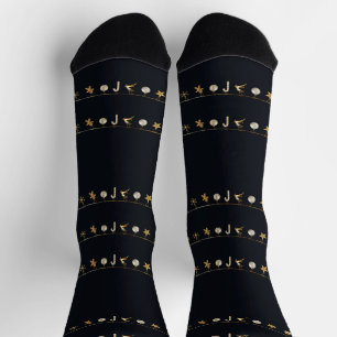Gold hanging Xmas ornaments on black Socks
