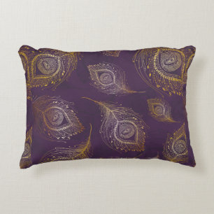 Gold peacock feather in violet background decorative cushion