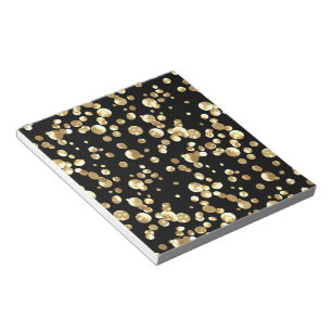 Gold polka dots on a black background . notepad