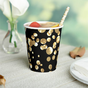 Gold polka dots on a black background . paper plat cups