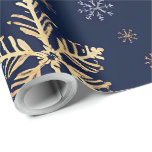 Gold Snowflake Pattern Wrapping Paper<br><div class="desc">This image features a roll of elegant gift wrapping paper decorated with large, artistic gold-coloured snowflake designs set against a deep navy blue background. The pattern includes various intricate snowflake shapes, some highlighted with a gold metallic effect and others in subtle contrasting tones. This luxurious and festive wrapping paper is...</div>