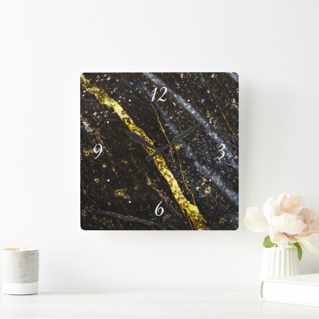 Gold sparkly line on black rock with clock face (Home)