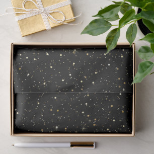 Gold tone glitter and sparkles on black tissue paper