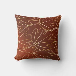 Golden autumn leaves pattern on brown cushion
