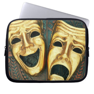 Golden comedy and tragedy masks on patterned laptop sleeve