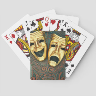 Golden comedy and tragedy masks on patterned playing cards