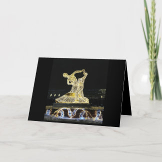 Golden dancing figures on black card