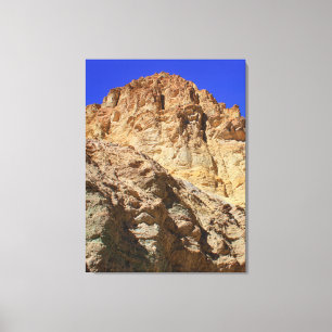 Golden Desert Cliff Under Blue Sky Canvas Print