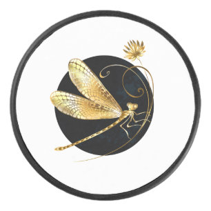 Golden dragonfly in black circle hockey puck