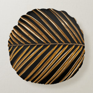 Golden painted date palm leaf closeup on abstract round cushion
