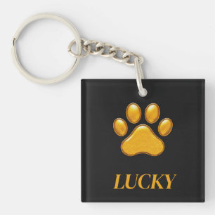 Golden Paw Print Against Black Background Key Ring