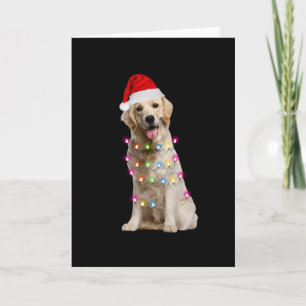 golden retriever sitting with christmas card