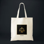 Golden Scales of Justice Law Theme Design Tote Bag<br><div class="desc">A tote bag with an image of golden scales on a black background. Simple and elegant.</div>