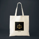 Golden Scales of Justice Law Theme Design Tote Bag<br><div class="desc">A tote bag with an image of golden scales on a black background. Simple and elegant.</div>