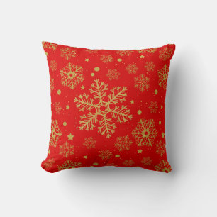 Golden snowflakes on red cushion