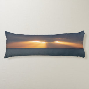 Golden sun rays breaking through the clouds sunset body cushion