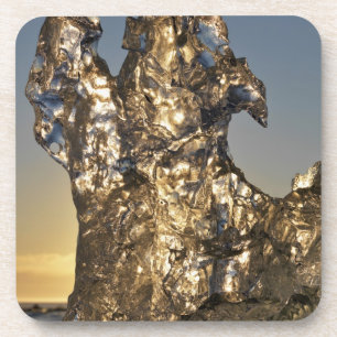 Golden sunrise seen through iceberg formation coaster