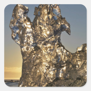 Golden sunrise seen through iceberg formation square sticker