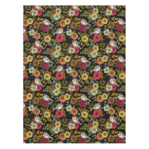 Goldfinches in the garden on black tablecloth