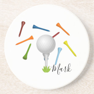 Golf ball and colourful tee on white coaster