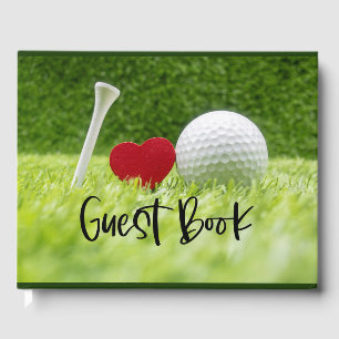 Golf ball and tee on green grass with love guest book
