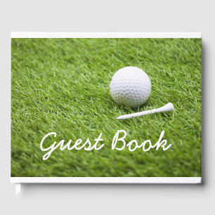 Golf ball and white tee are on green grass golfer guest book