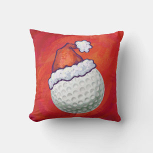 Golf Ball in Santa Hat on Red Cushion