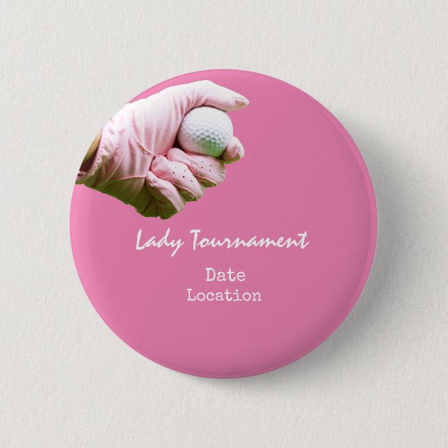 Golf ball is in lady golfer's hand on pink 6 cm round badge (Front)