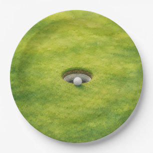 Golf ball is next to the hole on putting green paper plate