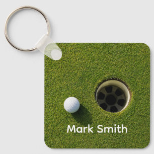 Golf Ball Next to Hole on Green Grass Golf Course Key Ring